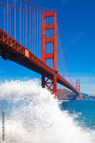 Fotografie, Obraz Golden Gate Bridge with big wave splash and spray in the foregro