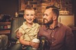 © Nejron Photo - Stylish little boy and his father in a barber shop