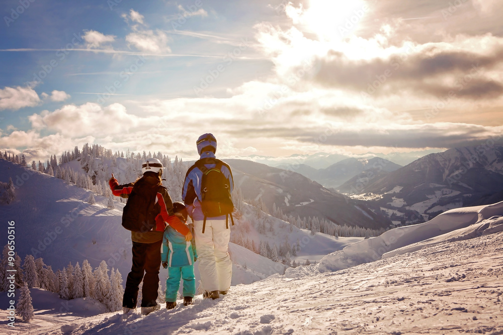 Happy family in winter clothing at the ski resort, winter time - obrazy, fototapety, plakaty 