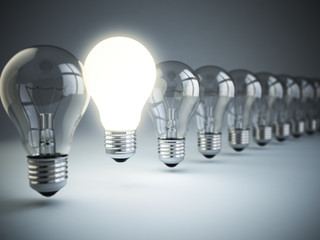 Poster - Idea or uniqueness, originality concept. Row of light bulbs with