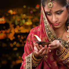 Wall Mural - Indian girl hands holding diwali oil lamp