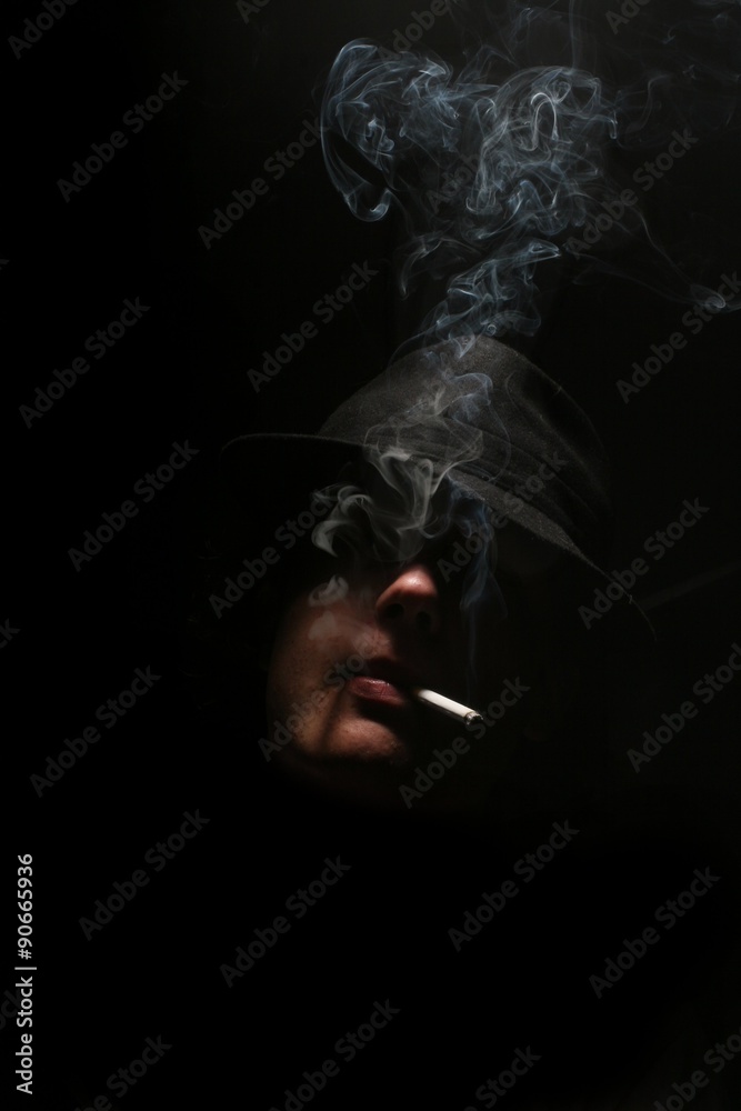 Man smoking in the dark Stock Photo