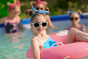 Wall Mural - Portrait of children on the pool in summer