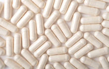 Medical Background With White Capsules