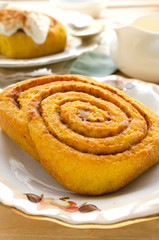 Wall Mural - Homemade pumpkin cinnamon rolls with spices and sweet cream