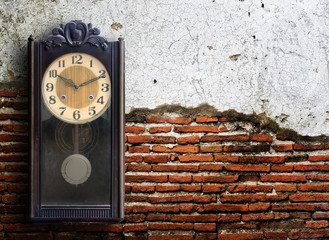 Old clock on grunge wall.