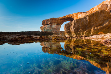 Wall Mural - Azure Window, famous stone arch on Gozo island with reflection,