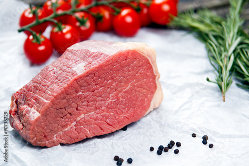 a pieces of fresh meat, beef slab, decorated with greens and vegetables Poster