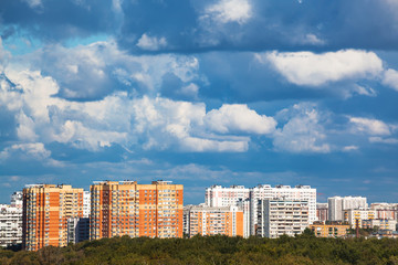 Sticker - heavy low blue clouds over modern urban houses