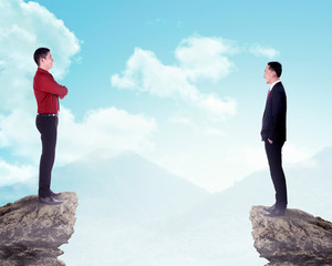 Two business man standing on the top of the mountain