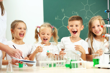 Wall Mural - Cute pupils doing biochemistry research in chemistry class