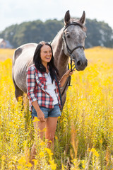 Wall Mural - Young woman with a horse