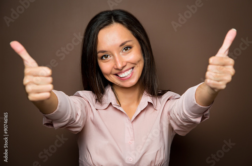 Fotografie, Obraz Woman giving thumbs up approval hand sign gesture smiling happy