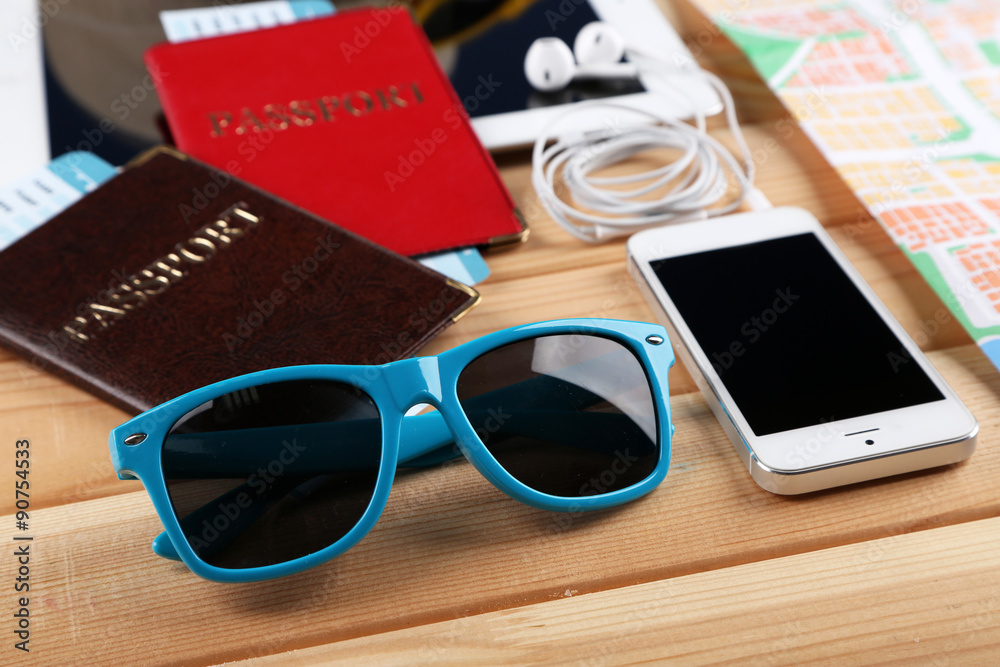 Sunglasses, passports and map, close up, on wooden background. Preparing for travel concept
