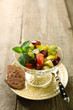Fruit salad in glass bowl, on wooden background