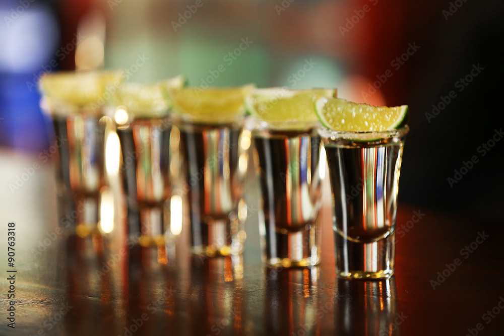 Shot glasses with tequila on bar counter