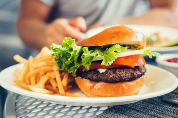 Wall Mural - Fresh burger with cheeseand french fries outdoors