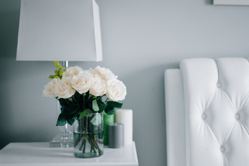 Bouquet of white pastel roses in white interior