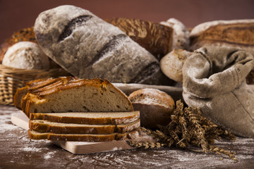 Wall Mural - Freshly baked traditional bread on wooden table