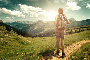 Wall Mural - hiker enjoying the view from mountain valley trail