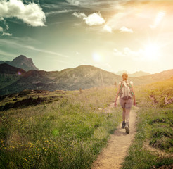 Wall Mural - woman hiking on remote mountain valley trail