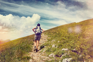 Wall Mural - female hiker pausing for a break on mountain trail
