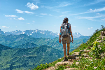 Wall Mural - female hiker ascending steep mountain trail