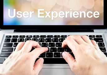 Poster - User experience word on laptop screen with hand type on keyboard