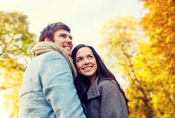 Wall Mural - smiling couple hugging in autumn park