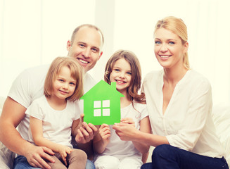 Wall Mural - smiling parents and two little girls at new home