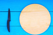 Cutting board and knife on wooden kitchen table