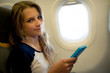 Portrait of using smart-phone in the plane