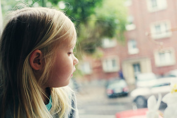 Portrait of 5 years old girl looking to the street