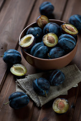 Poster - Ripe plums in a glass bowl, selective focus, studio shot