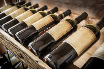 Old wine bottles on the wine shelf.