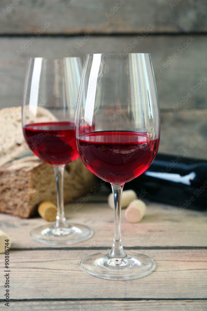Still life of wine and bread on light background