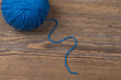 © Room 76 Photography - Ball of blue knitting yarn on wooden surface