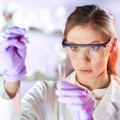 Poster - Young scientist pipetting in life science laboratory.