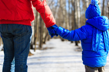 father and son holding hands in winter