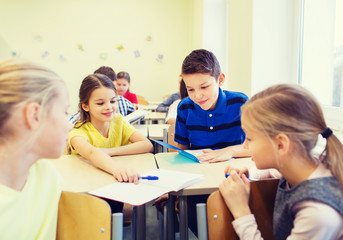 Wall Mural - group of school kids writing test in classroom