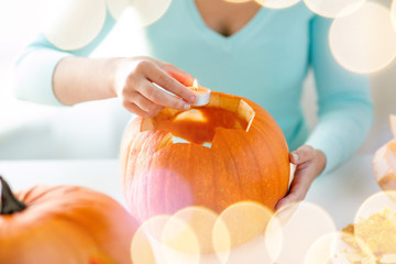 Wall Mural - close up of woman with pumpkins at home