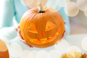 Wall Mural - close up of woman with pumpkins at home