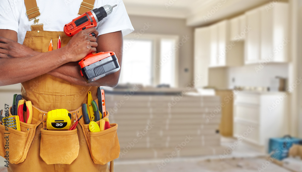 Builder handyman with construction tools. - obrazy, fototapety, plakaty 