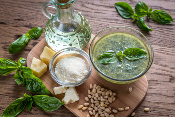 Wall Mural - Pesto with ingredients on the wooden table