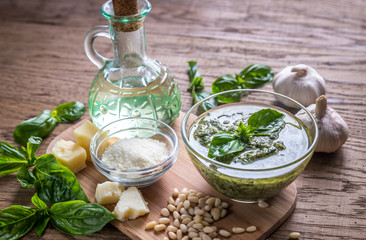 Wall Mural - Pesto with ingredients on the wooden table