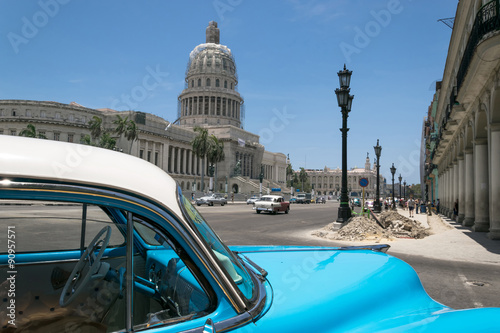 Fototapeta na wymiar Blue car at the Capitolio in Havana, Cuba