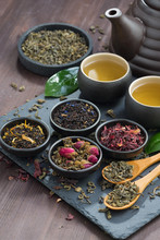 Assortment Of Fragrant Dried Teas And Green Tea On Wooden Table