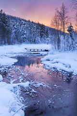 Sunrise over a river in winter near Levi, Finnish Lapland