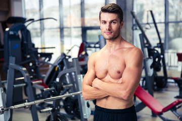 Poster - Man standing with arms folded at gym