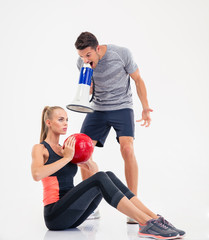 Poster - Coach shouting through loudspeaker on a  woman to doing exercises